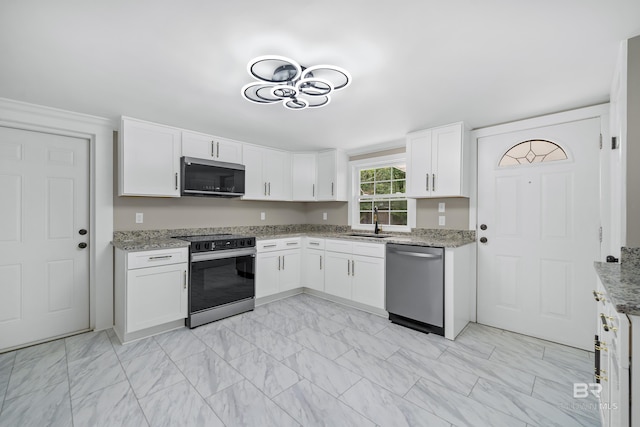1716 Bryan Ave, Mobile, AL 36605 - kitchen featuring dishwasher, range with electric stovetop, light marble finish flooring, white cabinetry, and light stone counters