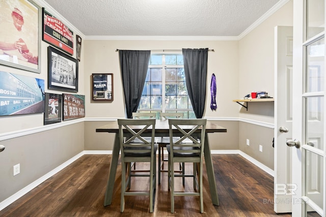 dining room featuring dark wood-type flooring, crown molding, and a textured ceiling