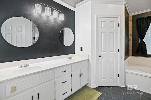 bathroom featuring vanity, a bathtub, a textured ceiling, tile patterned flooring, and ornamental molding