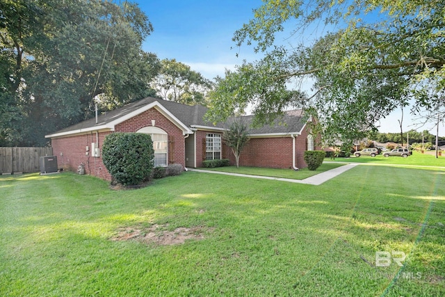 single story home featuring a front yard and central AC unit