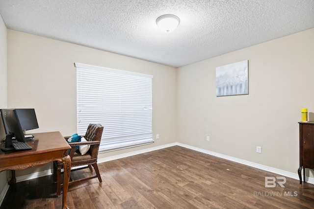 office with a healthy amount of sunlight, hardwood / wood-style flooring, and a textured ceiling