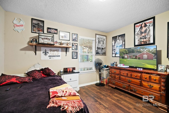 bedroom featuring dark wood-type flooring and a textured ceiling