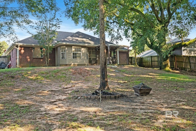 back of house featuring a fire pit