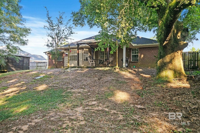 back of house with glass enclosure