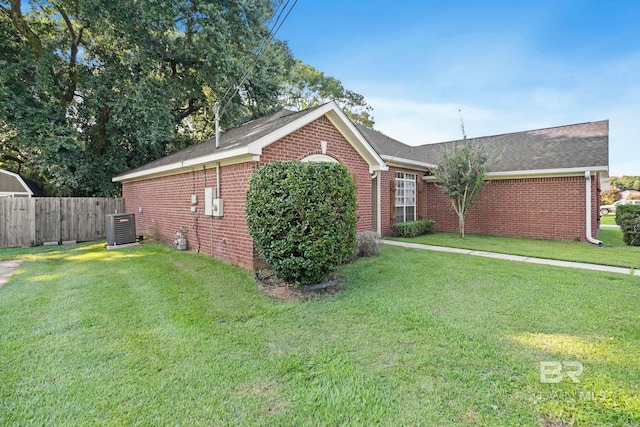 view of front of property featuring central AC and a front yard