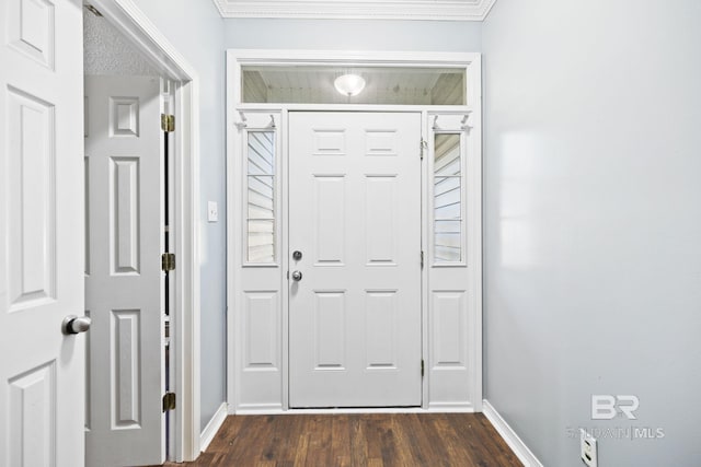 foyer with ornamental molding and dark wood-type flooring