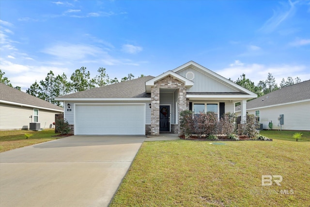 view of front of house featuring a front lawn, central AC unit, and a garage