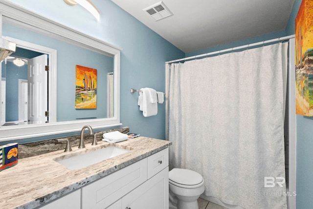 bathroom featuring toilet, tile patterned floors, visible vents, and vanity