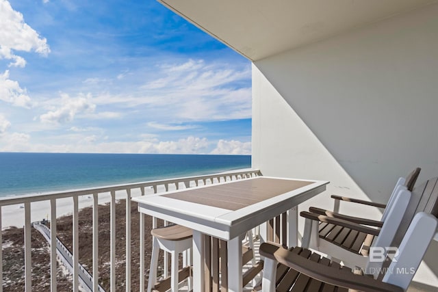 balcony featuring a water view and a view of the beach