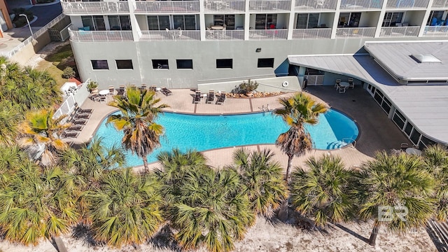 community pool featuring a patio and fence