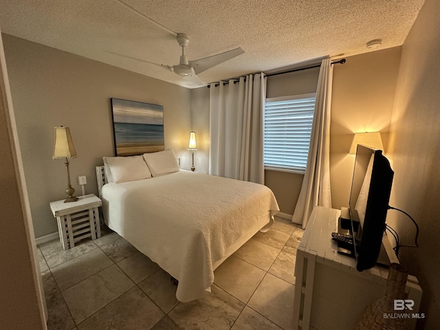 bedroom with ceiling fan and a textured ceiling