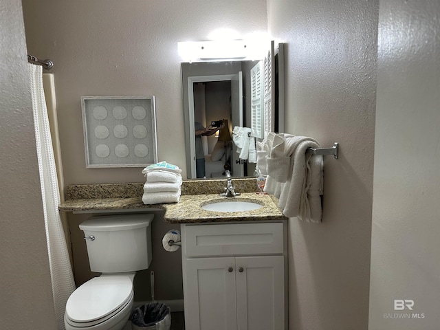 full bath with vanity and toilet