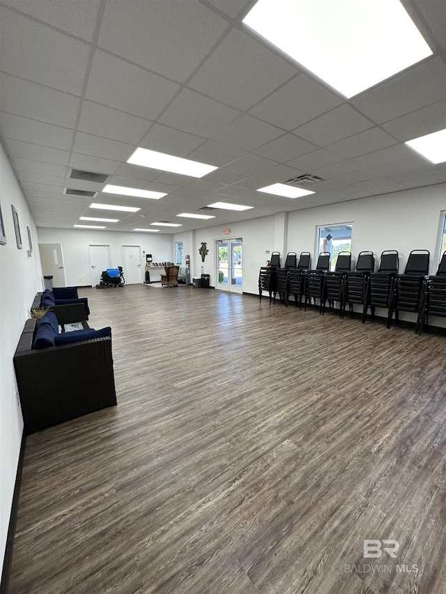 gym featuring a drop ceiling and wood finished floors