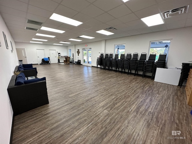 gym with french doors, a drop ceiling, wood finished floors, and visible vents