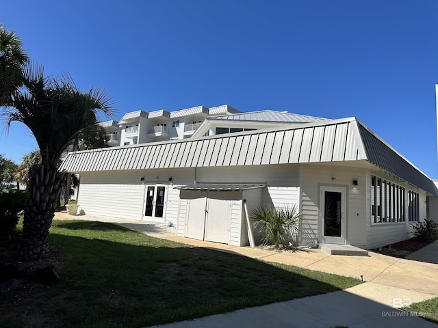 view of front of home with a front yard and metal roof