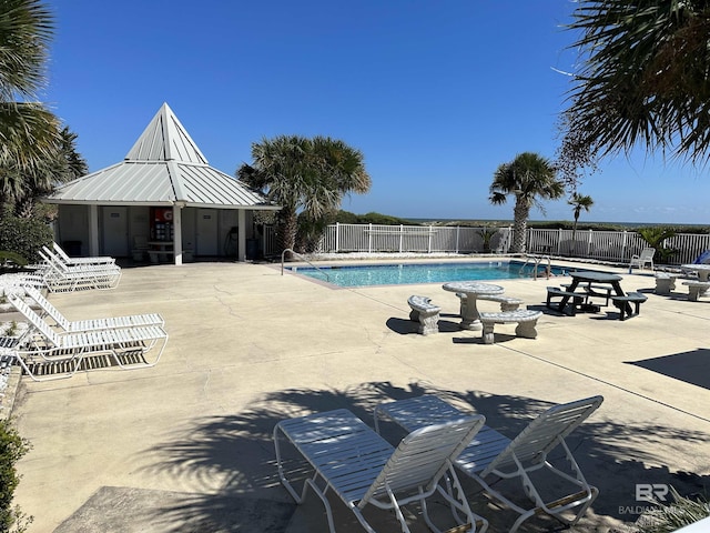 community pool featuring a patio area and fence