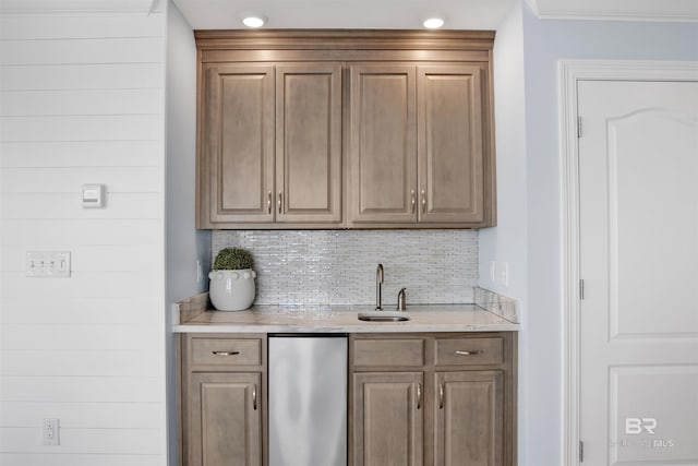indoor wet bar featuring fridge, decorative backsplash, and crown molding