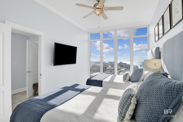 bedroom featuring ornamental molding, light tile patterned floors, and a ceiling fan
