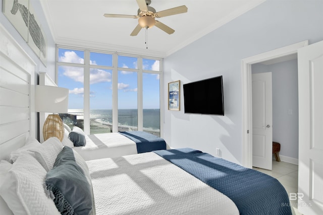 tiled bedroom with ornamental molding, a ceiling fan, and expansive windows