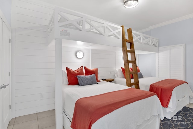 bedroom featuring crown molding and light tile patterned floors