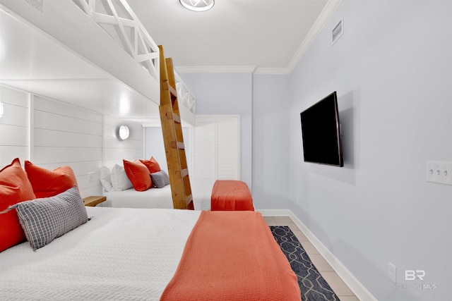 bedroom with crown molding, tile patterned floors, and baseboards