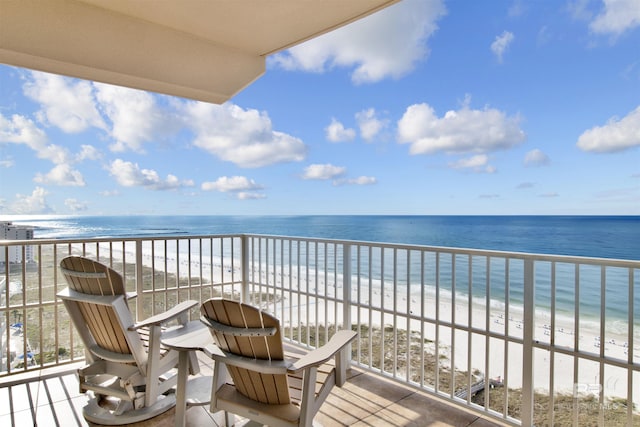 balcony with view of water and beach
