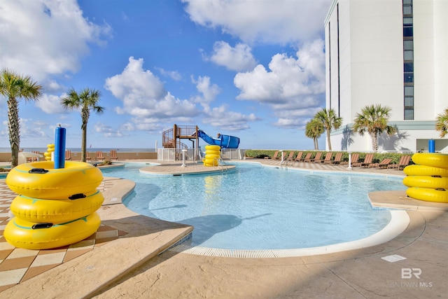 community pool featuring a water slide
