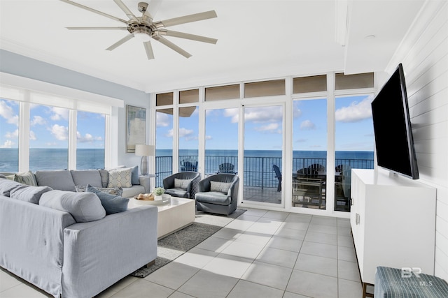 living room with a water view, light tile patterned floors, and ceiling fan