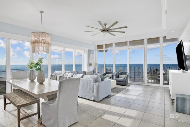 dining space featuring ceiling fan, light tile patterned flooring, a water view, and a wall of windows