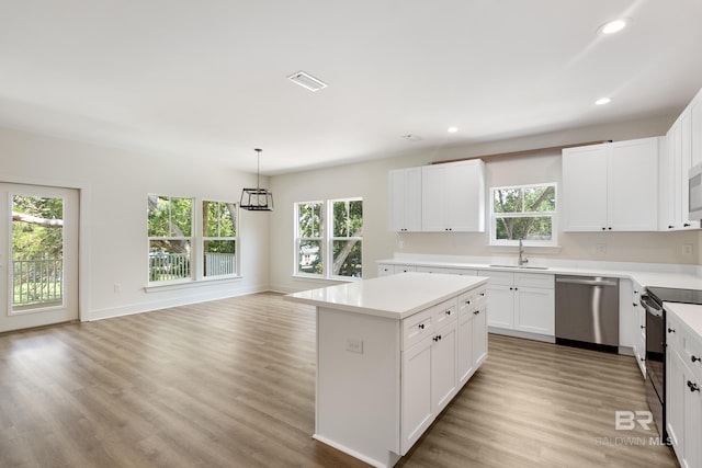 9264 Brighton Ave, Elberta, AL 36530 - kitchen featuring stainless steel dishwasher, a sink, black range with electric cooktop, healthy amount of natural light, and recessed lighting