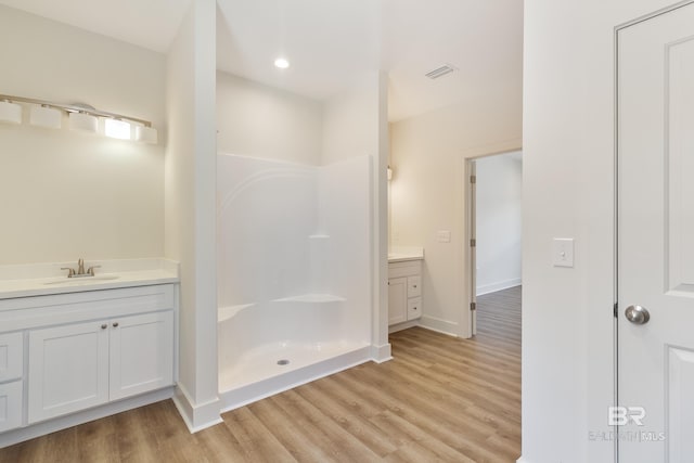 9264 Brighton Ave, Elberta, AL 36530 - full bathroom with vanity, wood finished floors, a shower, baseboards, and recessed lighting