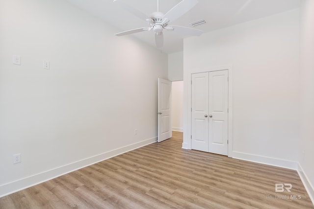 9264 Brighton Ave, Elberta, AL 36530 - unfurnished bedroom with light wood finished floors, baseboards, a closet, and a ceiling fan