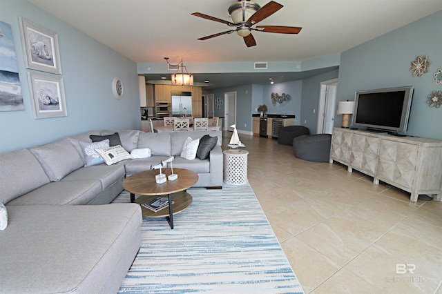 living room featuring ceiling fan and light tile flooring