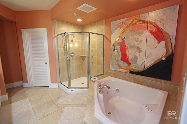 bathroom featuring tile floors and separate shower and tub