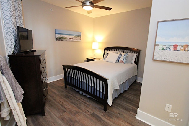 bedroom featuring ceiling fan, a water view, and dark wood-type flooring