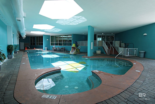 view of swimming pool with a skylight