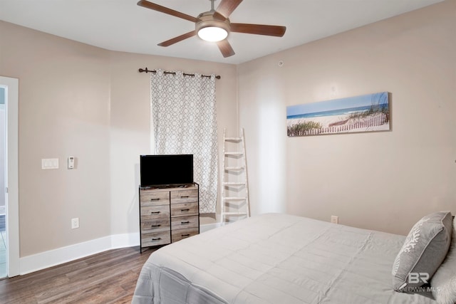 bedroom with ceiling fan and dark hardwood / wood-style flooring