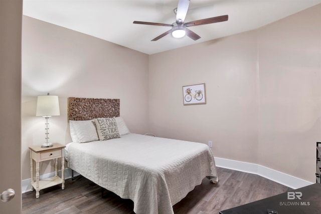 bedroom with ceiling fan and dark wood-type flooring