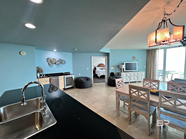 tiled dining area featuring beverage cooler and sink