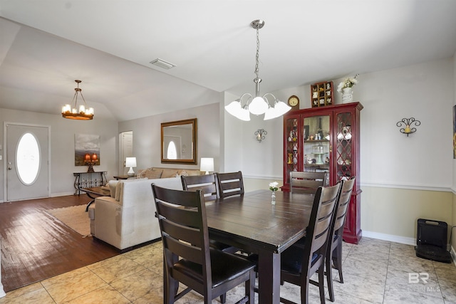 1500 Thames Dr, Foley, AL 36535 - dining space with lofted ceiling, visible vents, an inviting chandelier, and light tile patterned flooring