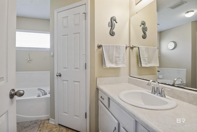 1500 Thames Dr, Foley, AL 36535 - full bathroom featuring a bath, vanity, visible vents, and tile patterned floors