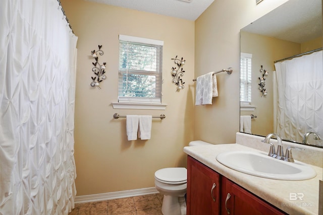 1500 Thames Dr, Foley, AL 36535 - bathroom with toilet, vanity, baseboards, and a healthy amount of sunlight