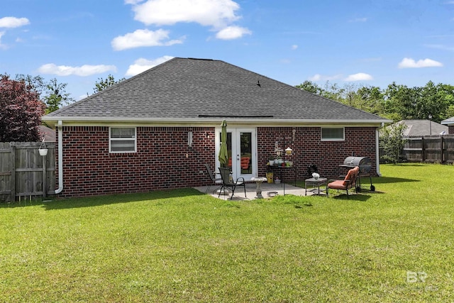 1500 Thames Dr, Foley, AL 36535 - rear view of house with a patio area, brick siding, a yard, fence, and a shingled roof