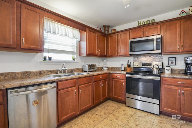 1500 Thames Dr, Foley, AL 36535 - kitchen featuring tasteful backsplash, light tile patterned floors, dark countertops, stainless steel appliances, and a sink