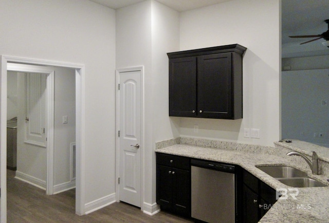 kitchen featuring light stone countertops, dishwasher, dark hardwood / wood-style floors, and sink