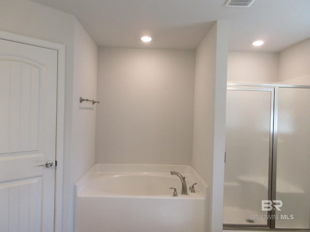 bathroom featuring independent shower and bath