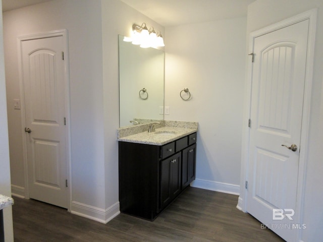 bathroom with hardwood / wood-style floors and vanity