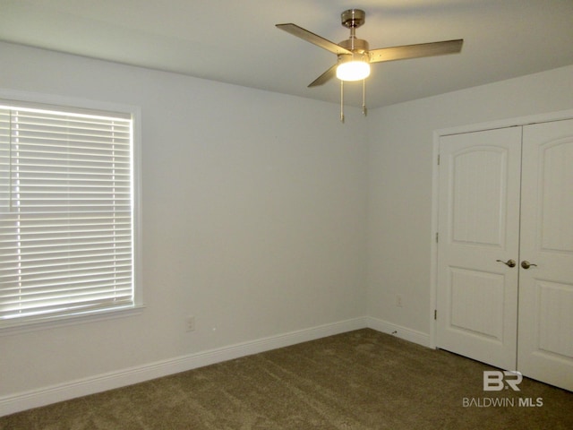 carpeted spare room with ceiling fan