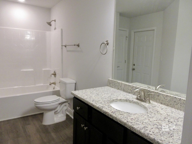 full bathroom with toilet, hardwood / wood-style flooring, vanity, and bathtub / shower combination