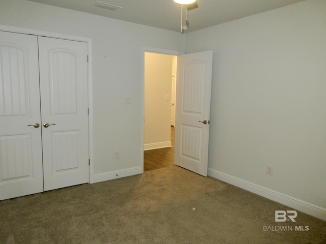 unfurnished bedroom with a closet and carpet